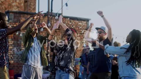 Young Stylish Woman And Happy Group Of People Dancing And Gaving Fun On The Rooftop