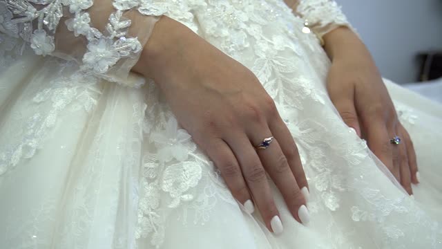 footages for video editing hands of the bride gently stroking the clothes dress