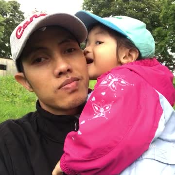 Dad and his daughter are playing outside