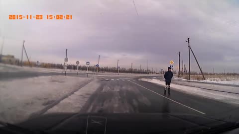 Man Skates on Black Ice Covered Road
