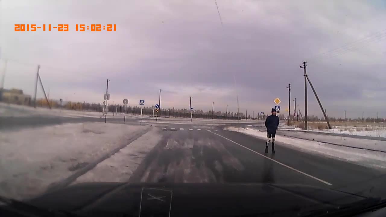 Man Skates on Black Ice Covered Road
