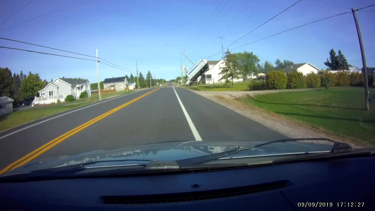 Sparks Fly as Truck Flips onto House