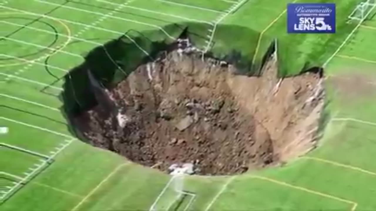 Moment a massive sinkhole, measuring 100 feet wide, engulfs a soccer field in Alton, Illinois.'