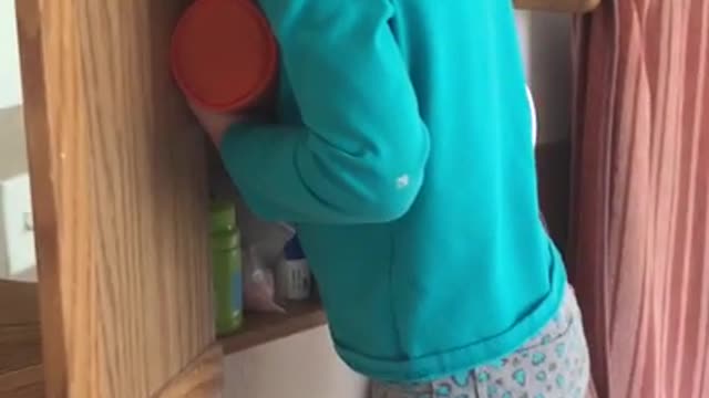 Girl hides her face after using her mother's makeup