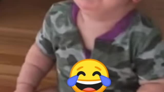 Adorable baby laughing hysterically at his mother's teasing