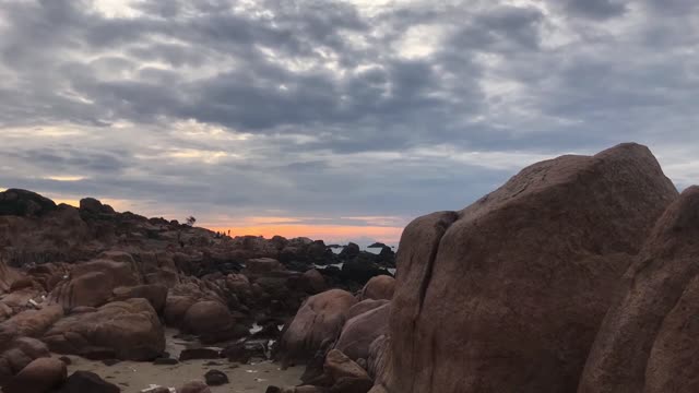 A Beautiful Time Lapse Video of People Walking on a Rocky Coast