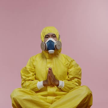 Man in lab suit doing yoga