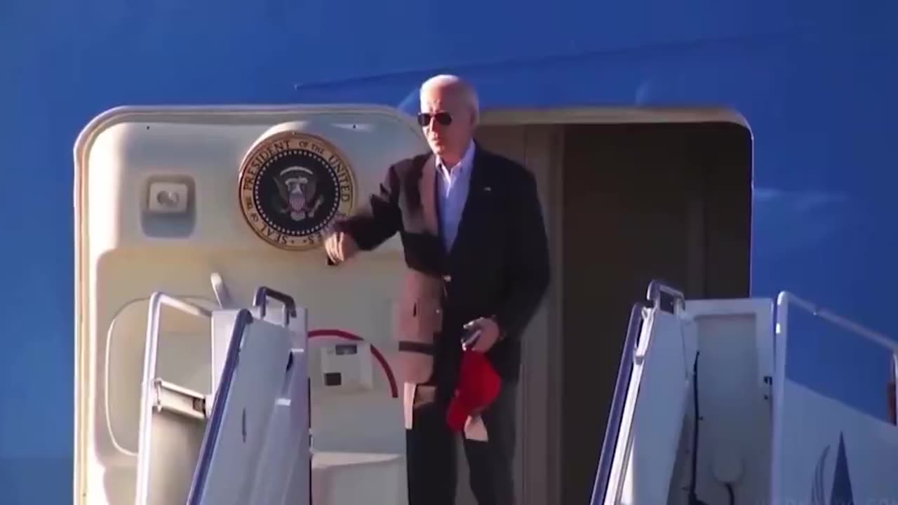 Biden is seen with another red hat a day after putting on Trump hat.