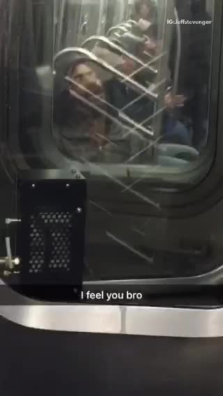 Long haired mustache man asleep on next car in subway