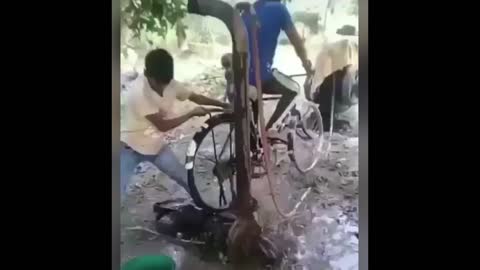 Smart thinking! TWO BOYS IN INDIA USED BICYCLE TO GET THE WATER OUT .SMART ISN'T IT
