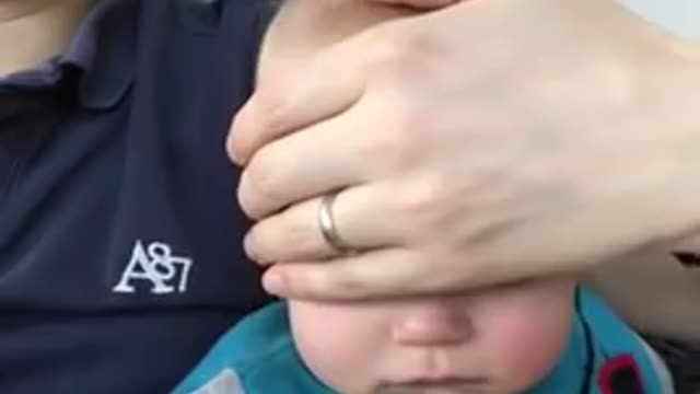 Dad Puts Baby to Sleep by Sliding Hand on Face