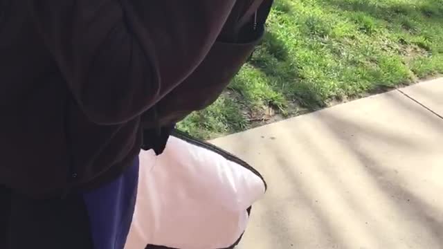 Guy carries surfboard in a giant bag