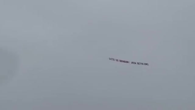 "Let's go Brandon!" flying banner seen in the sky. Glorious!