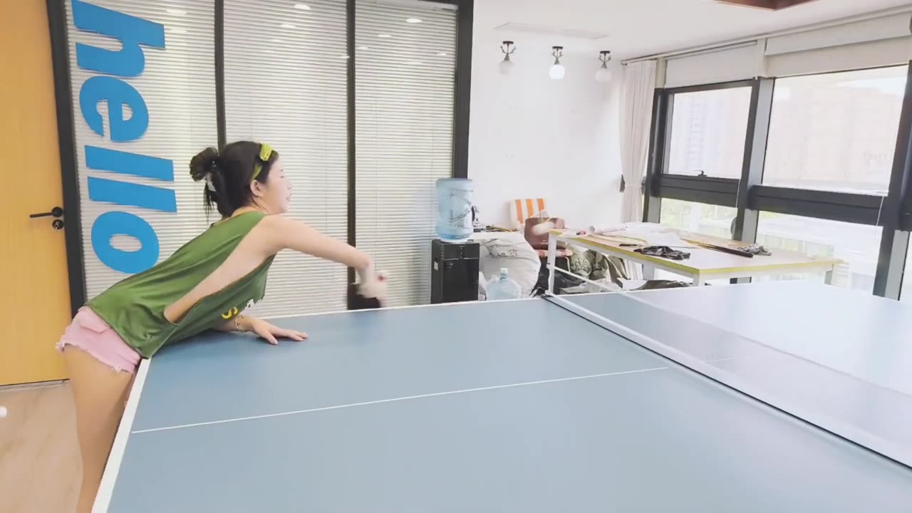 Sexy asia girl wearing green Low-cut vest playing table tennis