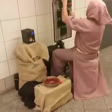 Guy in pink robe playing music