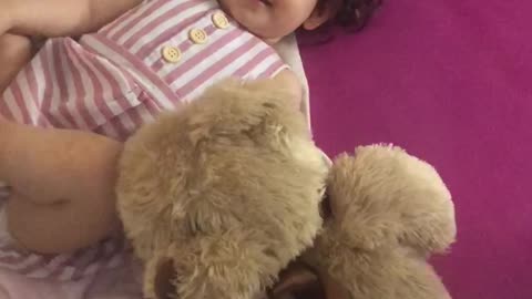 Baby girl with her teddy bear