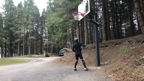 child jumping to hit basket