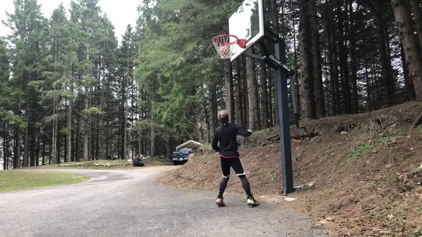 child jumping to hit basket