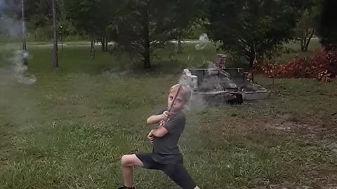 Kid with Roman Candle Takes Out Camera