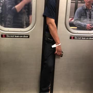 Guy with arm and leg stuck outside of subway door assistance