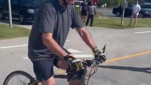 President Joe Biden falls off bike