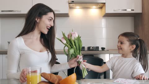 A Child Giving Her Mother Flowers