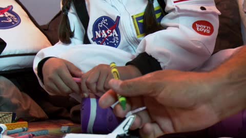 Little girl coloring with her father