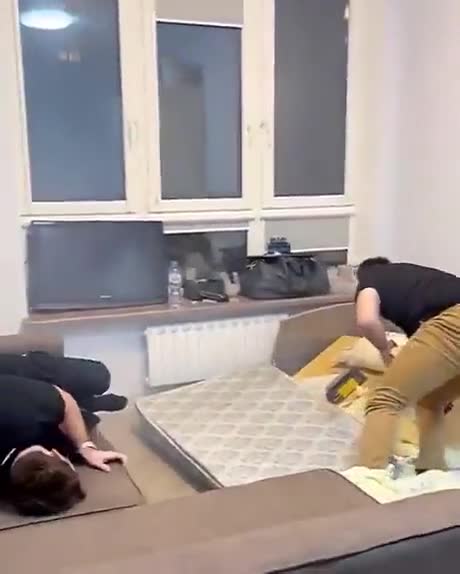 When the man is sitting quietly in bed on the phone and the bed is blown up