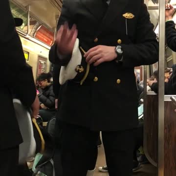 Army guys hold up different numbers to each other on subway