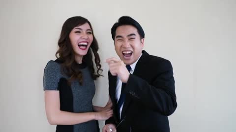 Two Happy Young Business People Laughing.