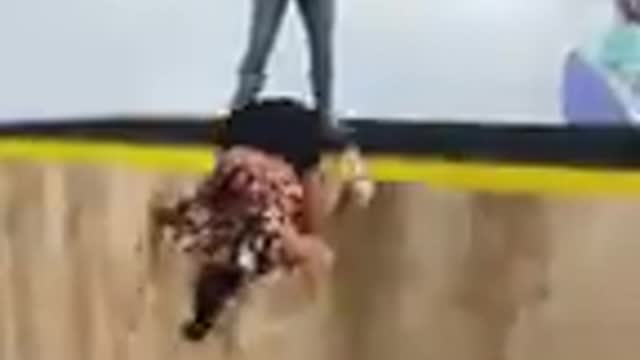 Girl Falls to the Ground Trying a Pull Over on a Trampwall