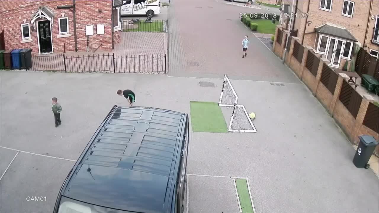 Little Kid Scores a Fluke Header While Boys Play Street Football