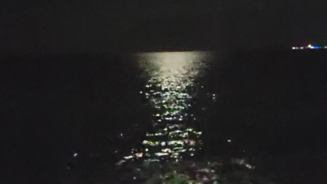 moonlight on the ocean as the waves come in at the beach at Secrets Resort in Playa Mujeres, Mexico