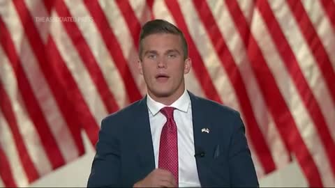 Paralyzed US House candidate stands during speech