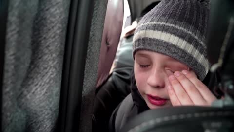 'We left our Dad in Kyiv' -little boy chokes back tears