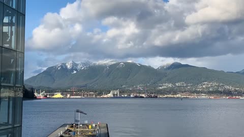 Small plane landing on water right near Canada place in Vancouver Canada