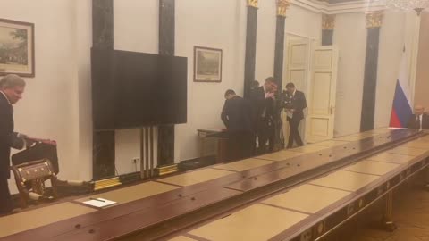 Putin's long table in a meeting room