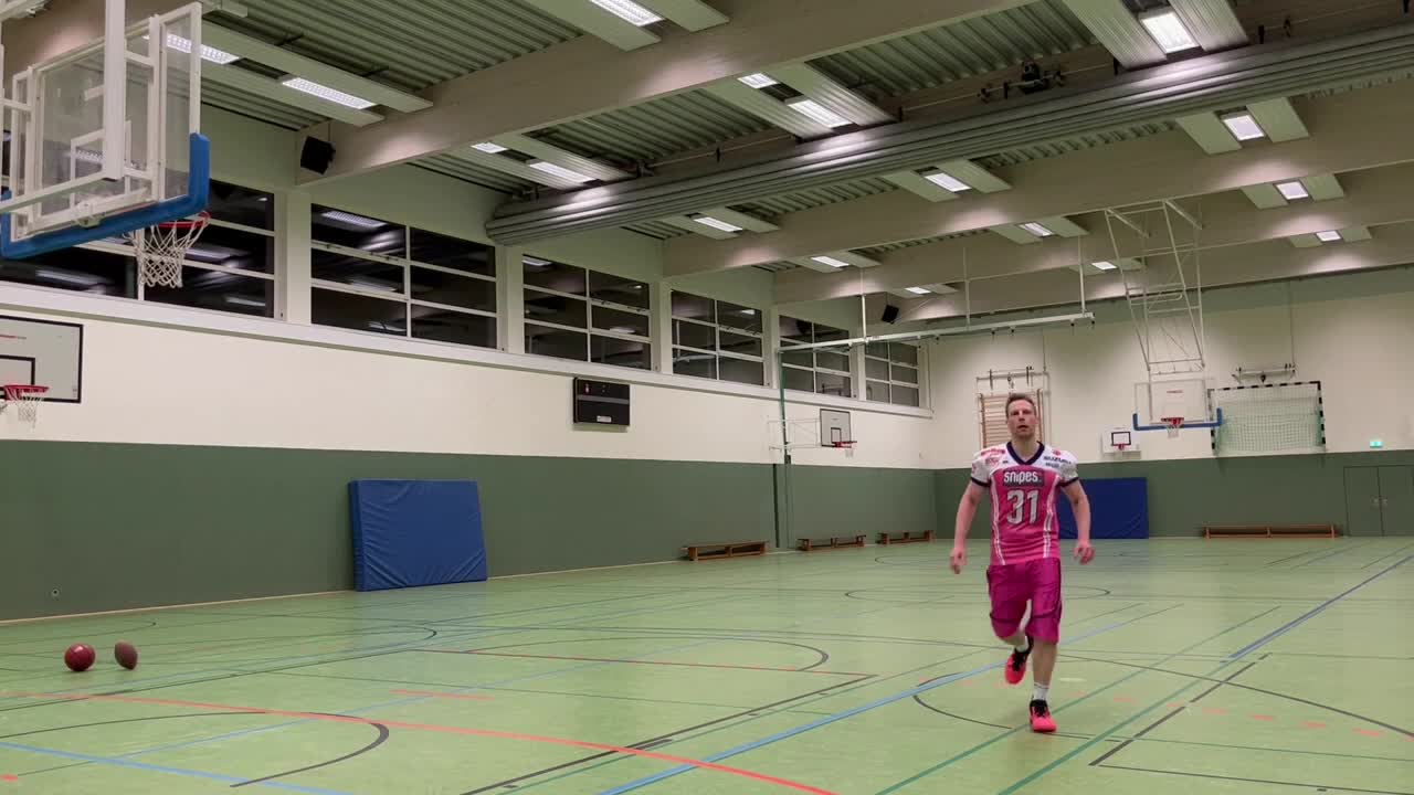Guy Spinned American Football and Kicked It Full Court Into the Basketball Hoop