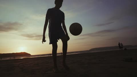 Solo football taps by the beach