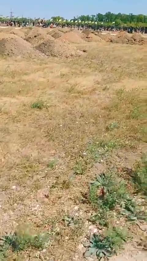 Fresh graves dug next to a large Ukrianian cemetery