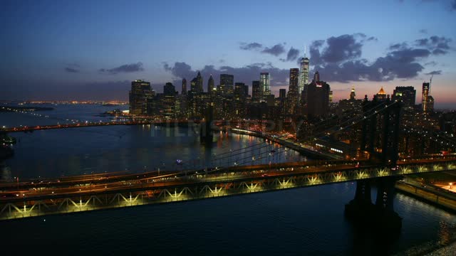 The brooklyn bridge is flown over at night