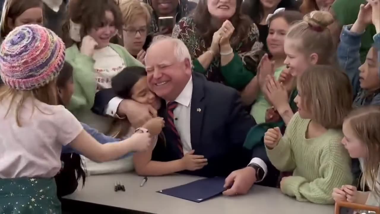 Tim Walz signing a law guaranteeing all students receive a free breakfast