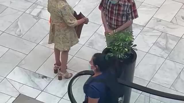 Grandparents Pull Plant from Pot in Mall