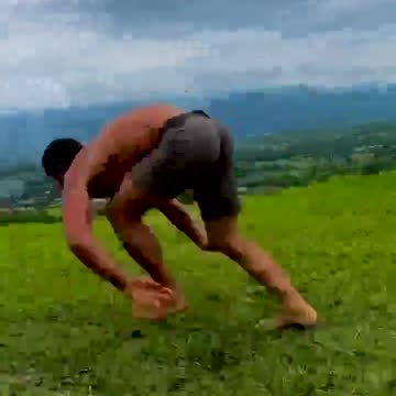 A man runs across the field like an animal