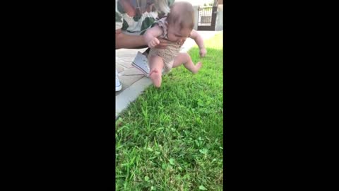 Baby girl refuses to let her feet touch the grass