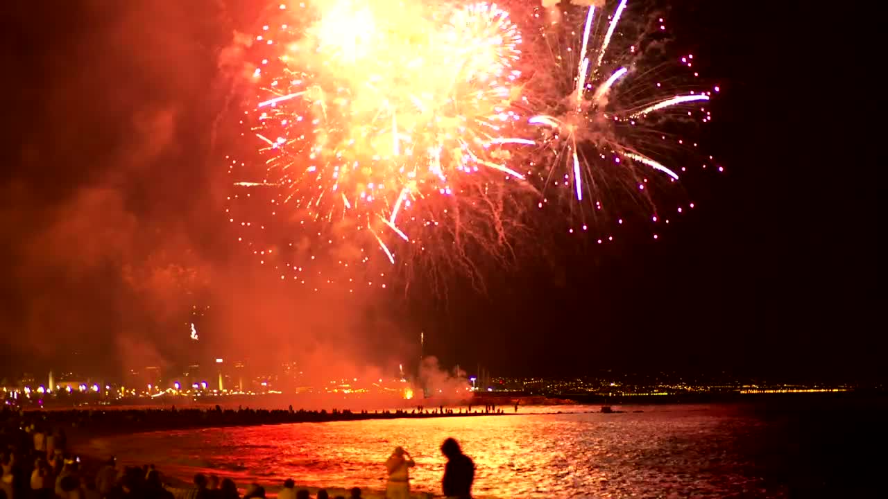 Fireworks illuminating the beach sky