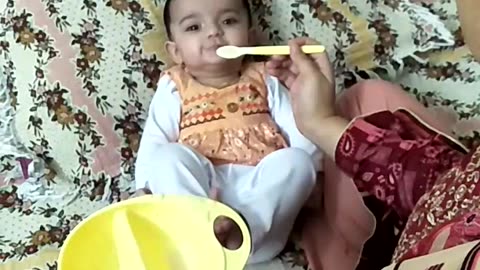 Baby eating serilac with spoon