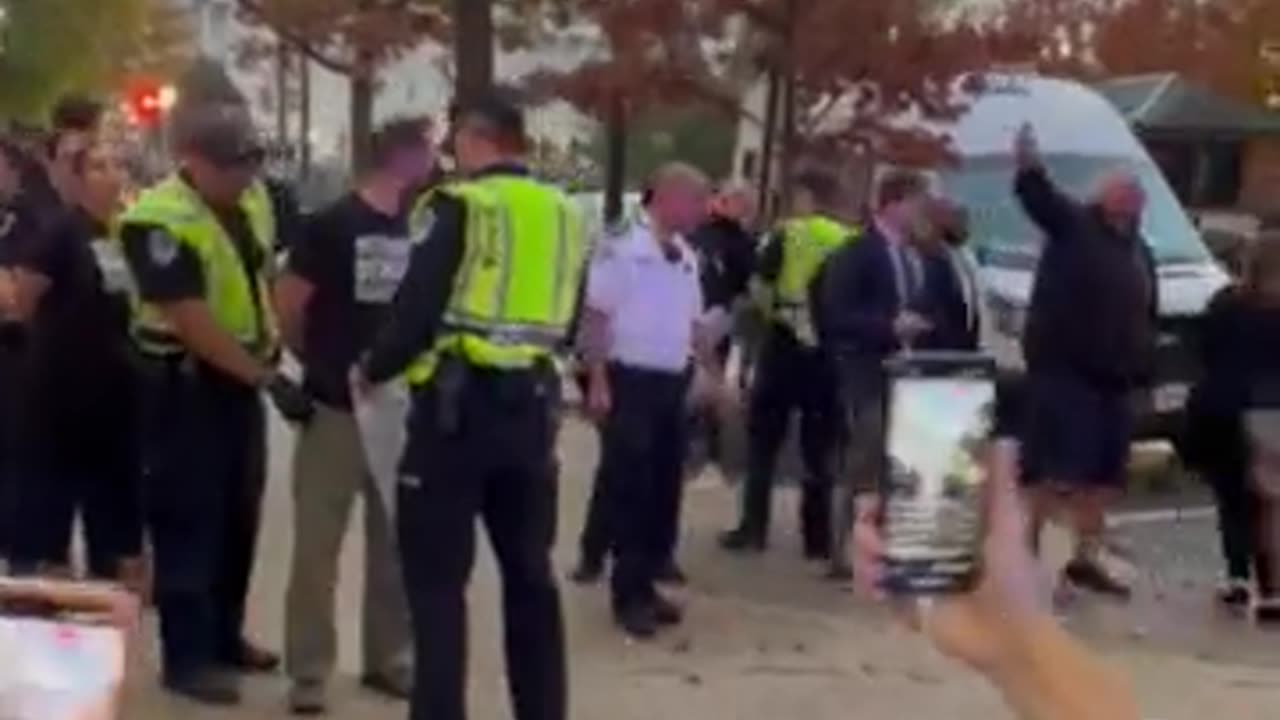 John Fetterman waves an Israeli flag at ceasefire protesters