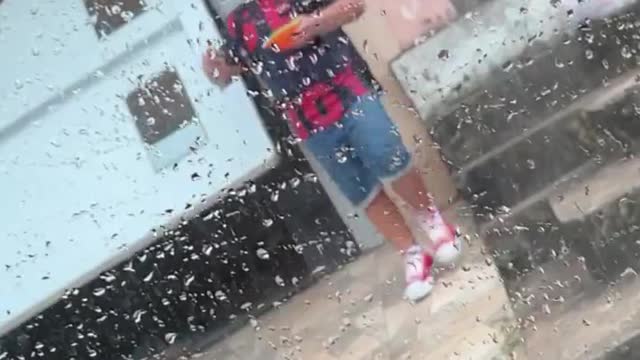 Little Brother Holding Tupperware Falls in Wet Driveway