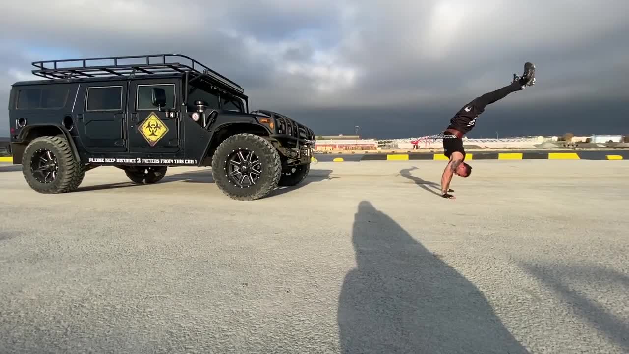 Guy Chains Jeep With His Torso and Pulls it While Performing Handstand